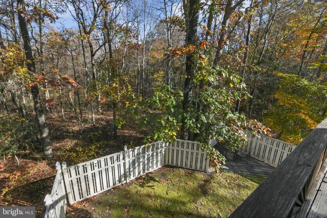 a view of balcony with wooden fence