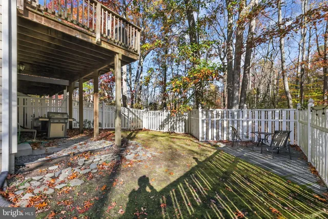 a view of a backyard with a wooden fence