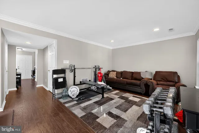 a living room with lots of furniture and a wooden floor