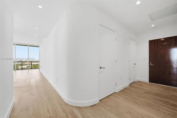 a view of a hallway with wooden floor