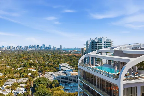 a porch with a table and chairs and potted plants
