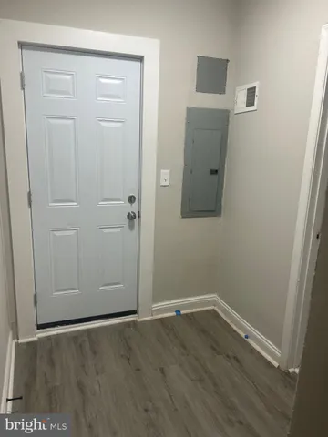 an empty room with wooden floor and closet