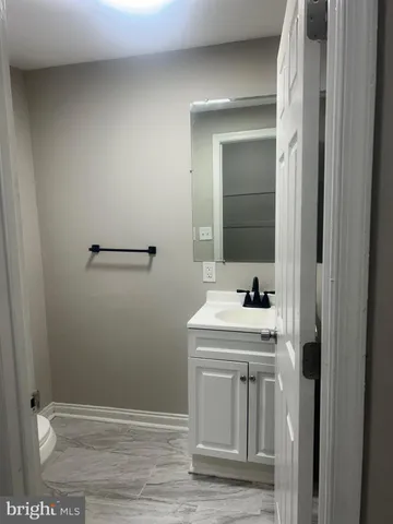 a bathroom with a sink a toilet and mirror