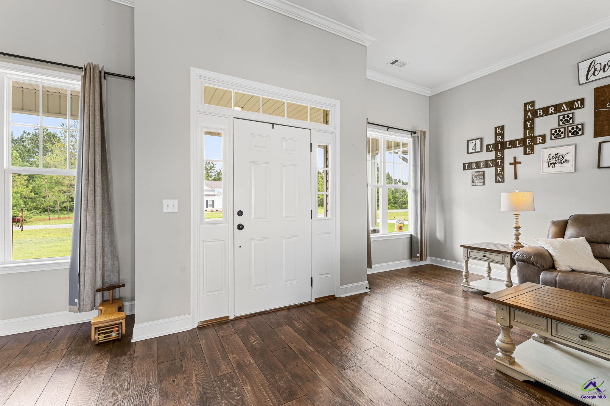 180 Woodland Trail Road Cochran, GA 31014 - Photo 4 of 25 a view of a livingroom with furniture wooden floor and windows