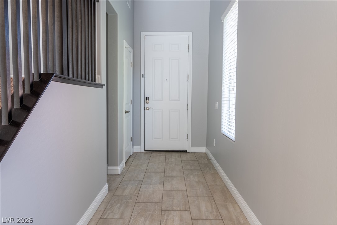 11045 Elk Sands Road Las Vegas, NV 89179 - Photo 8 of 67 Tiled flooring and soaring ceilings welcome visitors inside this bright entryway.