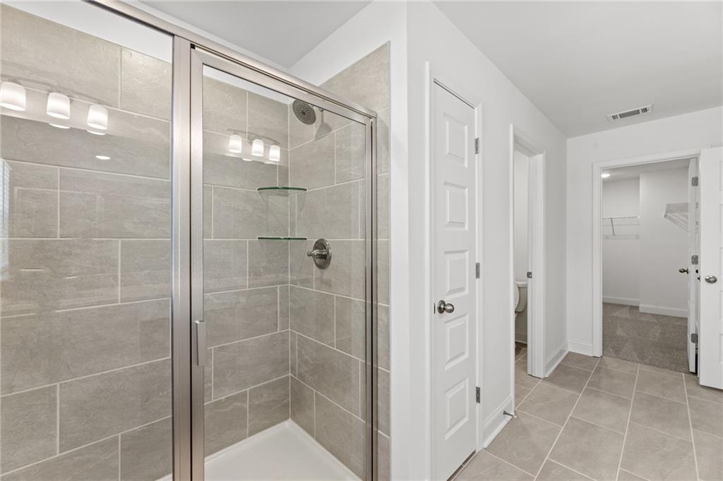 5629 Overview Drive Flowery Branch, GA 30542 - Photo 11 of 25 a bathroom with a glass shower door