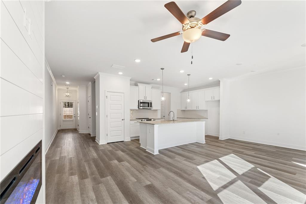 5629 Overview Drive Flowery Branch, GA 30542 - Photo 6 of 25 a view of kitchen with wooden floor and window