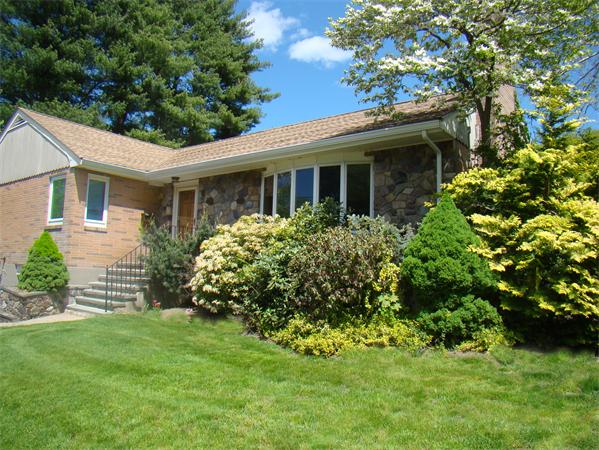 100 Deborah Road Newton, MA 02459 - Photo 1 of 5 a front view of a house with a garden