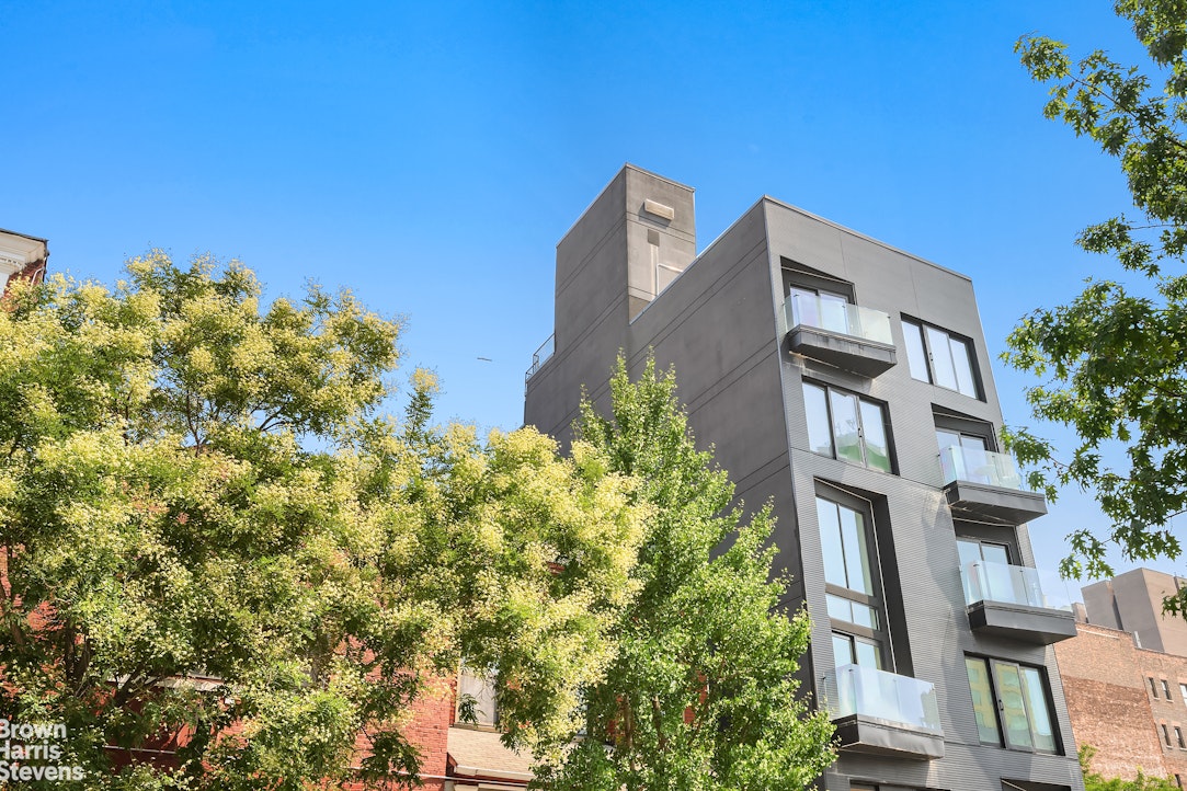 553 West 182nd Street, Unit 5R Manhattan, NY 10033 - Photo 10 of 12 a front view of a house with a yard