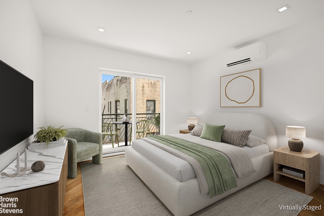 553 West 182nd Street, Unit 5R Manhattan, NY 10033 - Photo 6 of 12 a bedroom with a bed and a flat screen tv