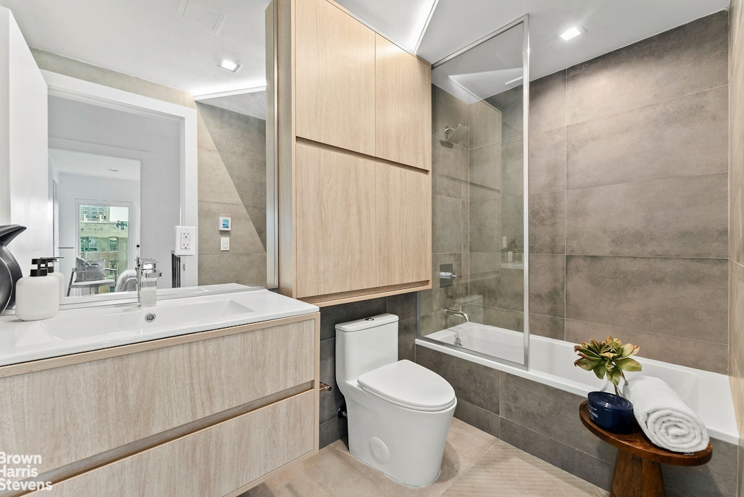 553 West 182nd Street, Unit 5R Manhattan, NY 10033 - Photo 8 of 12 a bathroom with a sink toilet and shower