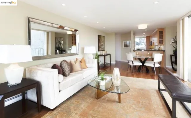 a living room with furniture a wooden floor and a large window