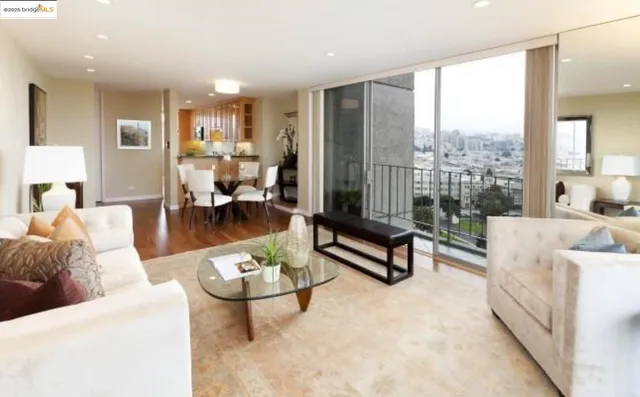 a living room with furniture a wooden floor and a large window