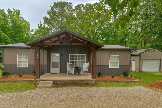 a front view of a house with a yard and porch