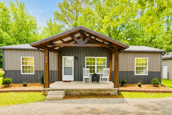 a front view of a house with a yard outdoor seating and garage