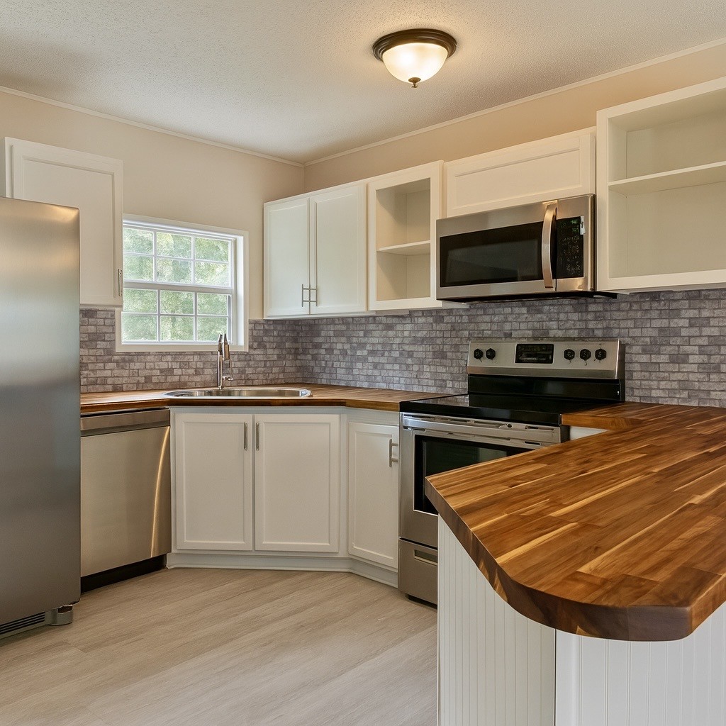 339 Old Flatwoods School Road Linden, TN 37096 - Photo 11 of 21 a kitchen with stainless steel appliances granite countertop a sink and a stove