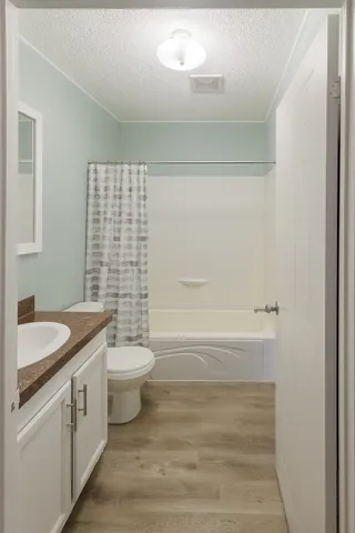 a bedroom with bed and a chandelier