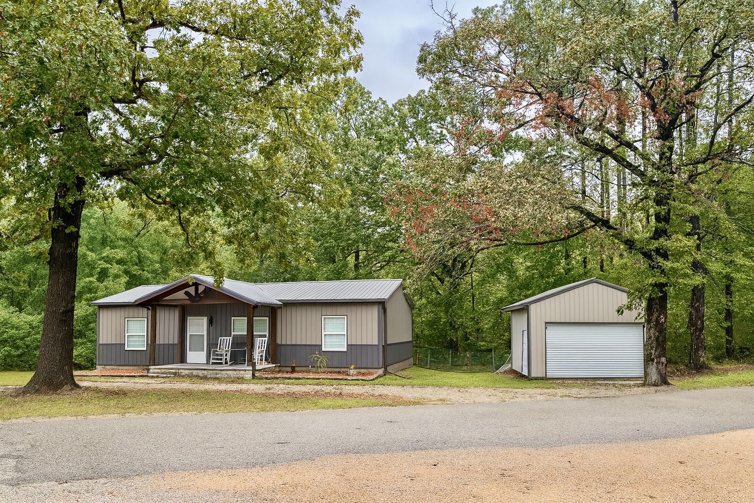 339 Old Flatwoods School Road Linden, TN 37096 - Photo 2 of 21 a white house that has a tree in front of it