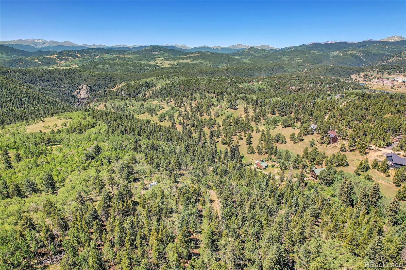 4 Hughesville Road Black Hawk, CO 80422 - Photo 4 of 29 a view of a lush green hillside and a mountain