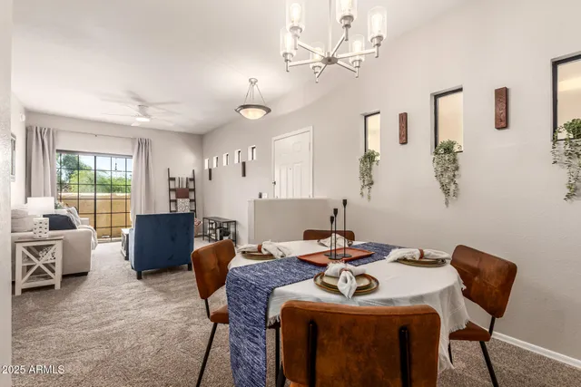a view of a a dining room with furniture window and wooden floor
