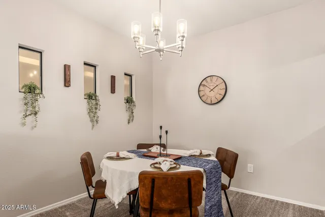 a view of a dining room with furniture and a chandelier