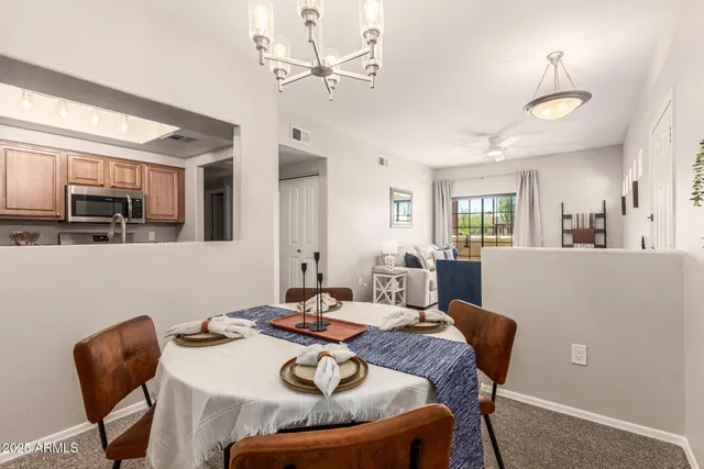 a view of a dining room with furniture and a chandelier