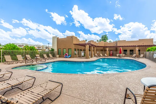 a view of a swimming pool with a lounge chairs