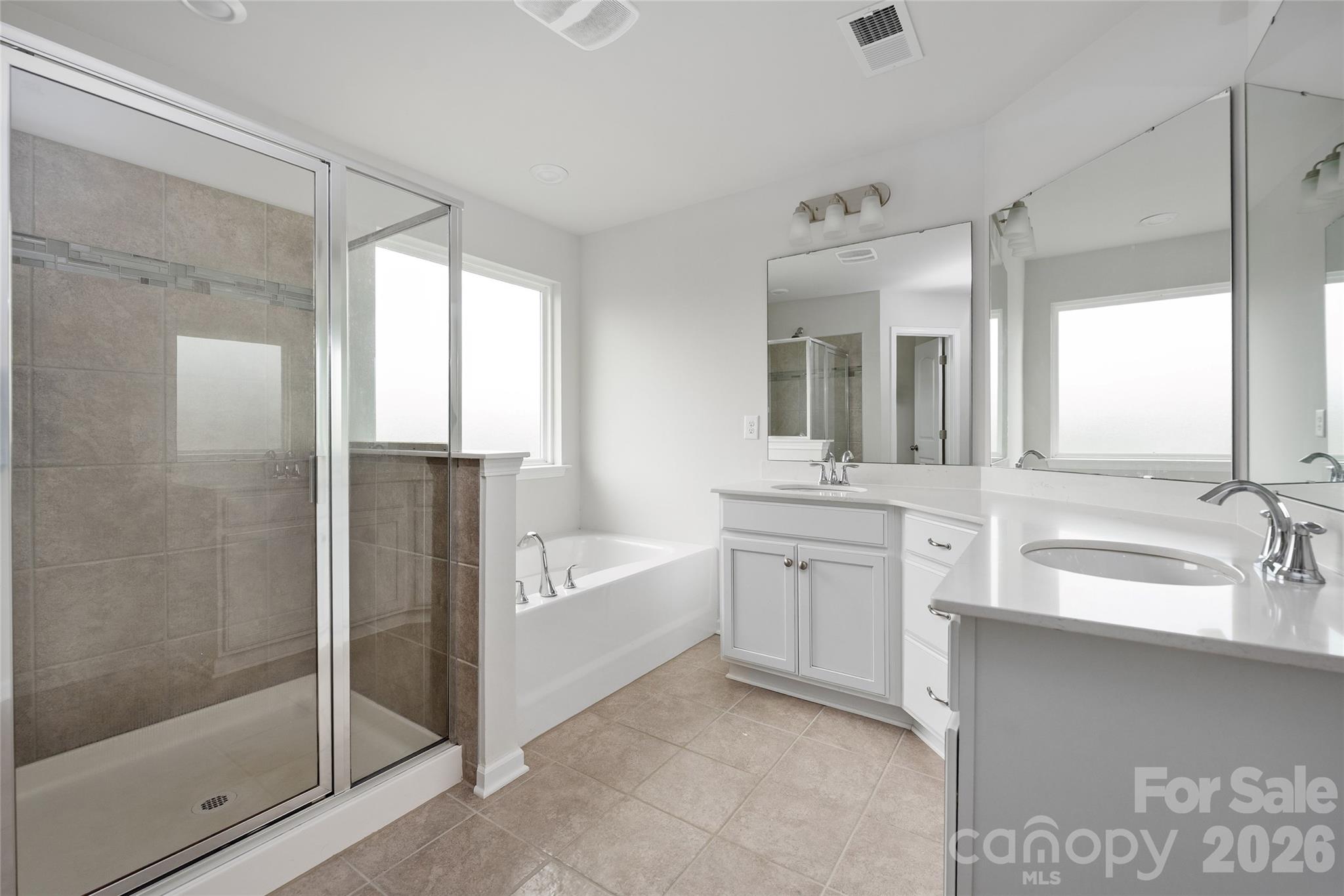 17219 Shearer Road Davidson, NC 28036 - Photo 19 of 34 a bathroom with a double vanity sink mirror and shower