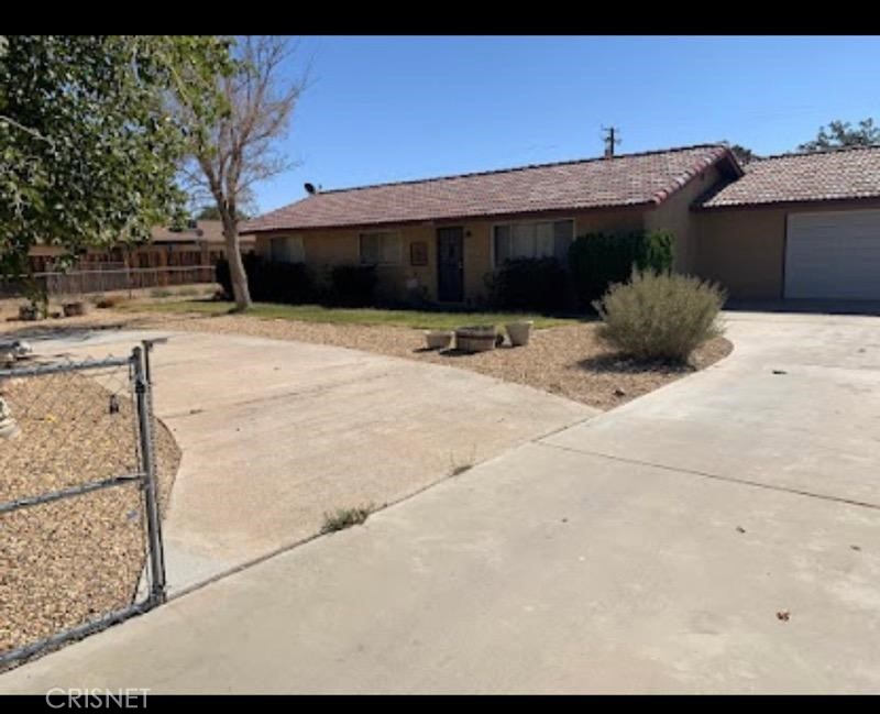 21115 Geronimo Road Apple Valley, CA 92308 - Photo 1 of 10 a front view of a house with a space