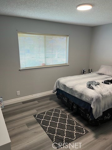 21115 Geronimo Road Apple Valley, CA 92308 - Photo 9 of 10 a bedroom with a bed and a window