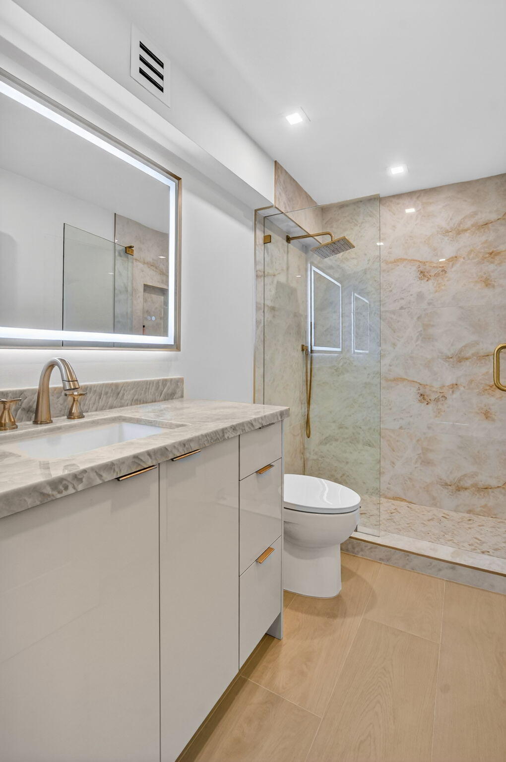 2800 South Ocean Boulevard, Unit 23C Boca Raton, FL 33432 - Photo 32 of 50 a bathroom with a toilet sink a mirror and shower