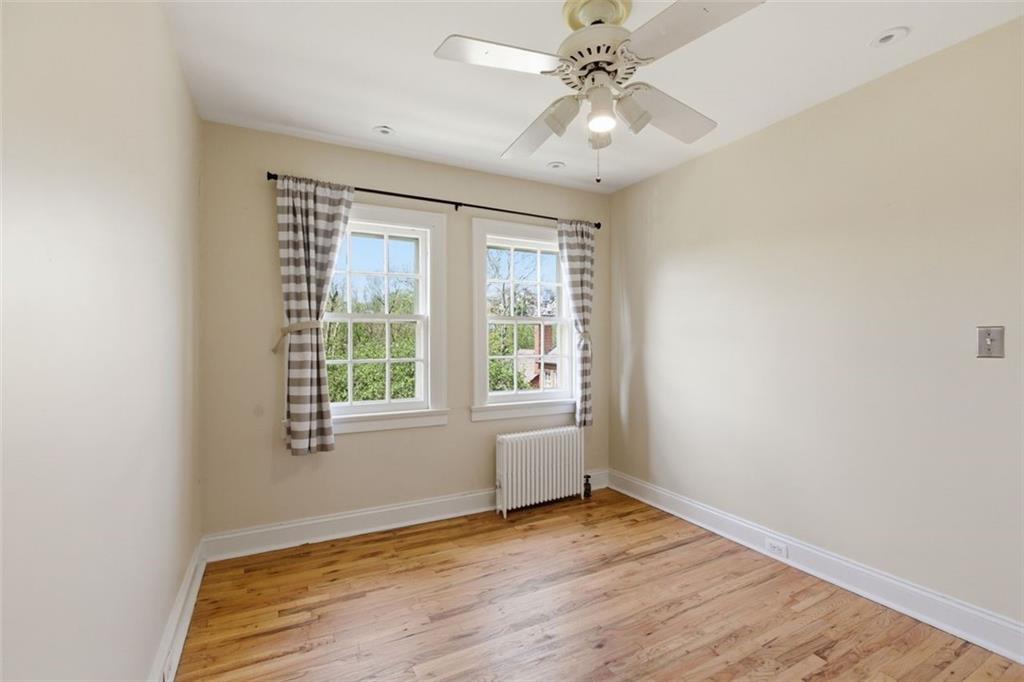 421 Olympia Road Pittsburgh, PA 15211 - Photo 20 of 34 an empty room with wooden floor fan and windows