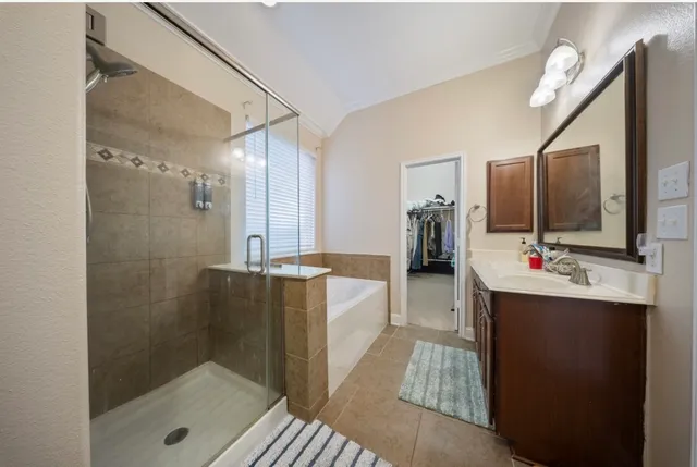 a bathroom with a sink a toilet a shower and a mirror