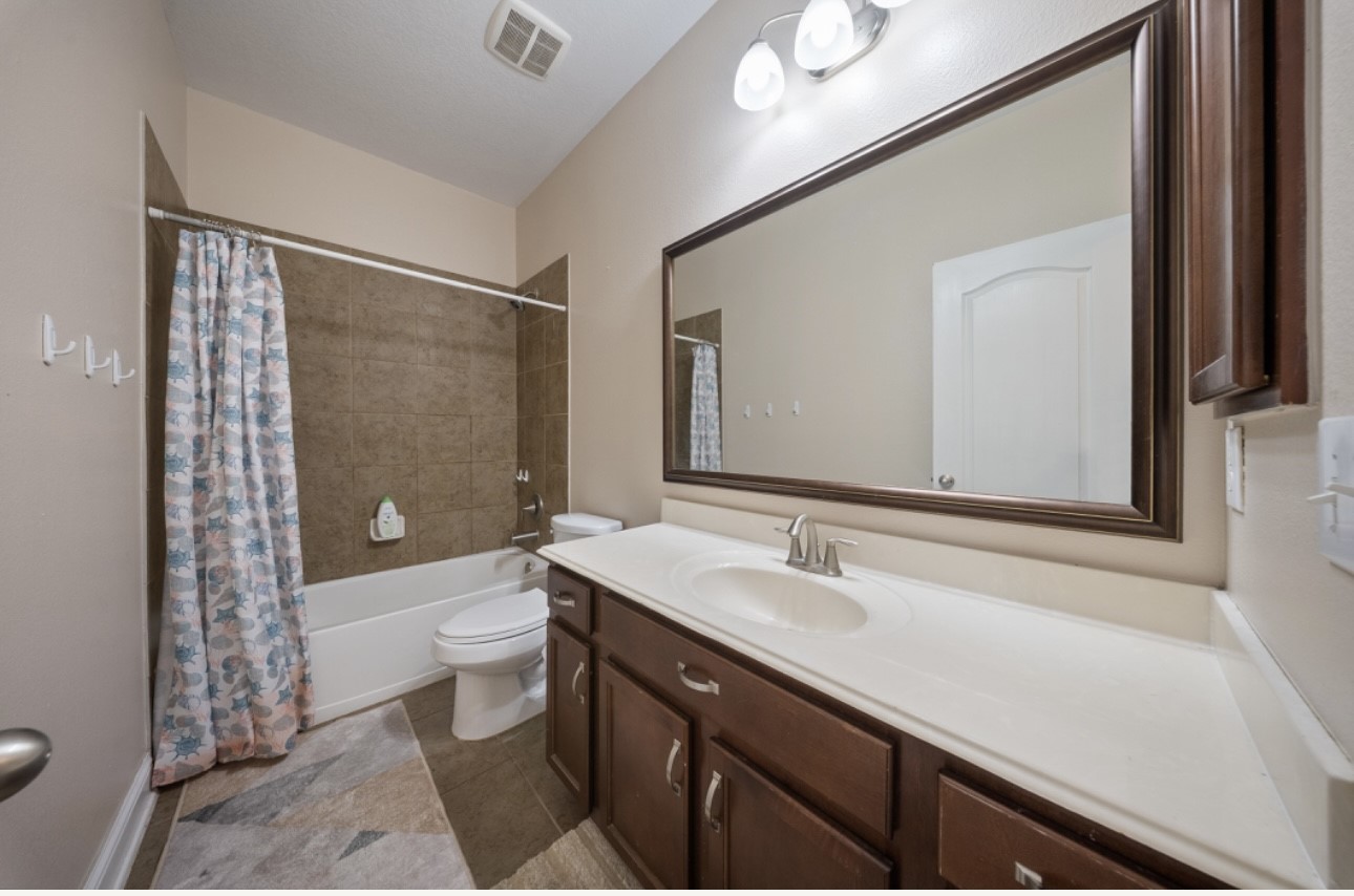 6130 Flagg Ranch Drive Spring, TX 77388 - Photo 12 of 15 a bathroom with a sink a toilet a shower and a mirror