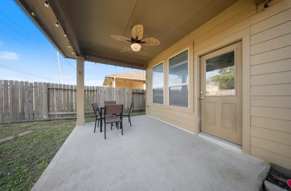 a view of a house with backyard and sitting area