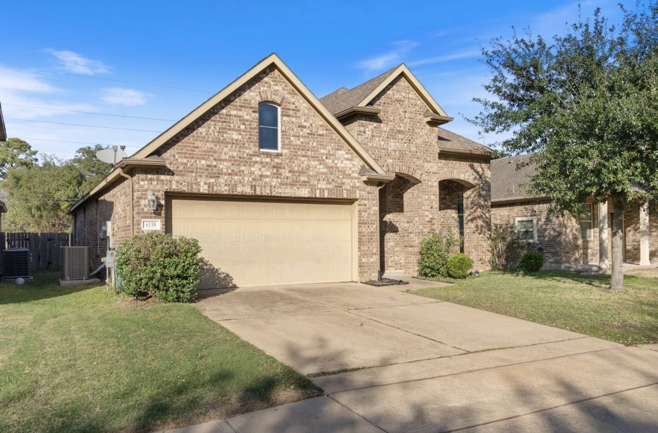 6130 Flagg Ranch Drive Spring, TX 77388 - Photo 2 of 15 a front view of a house with a yard and garage