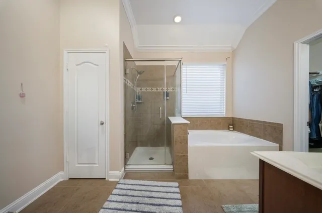 a bathroom with a tub sink shower and mirror