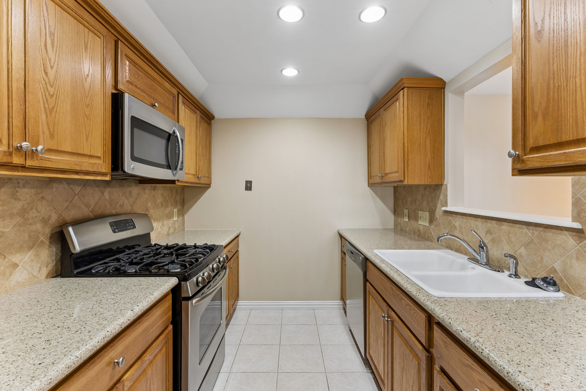 8340 Fathom Circle, Unit 103 Austin, TX 78750 - Photo 15 of 30 a kitchen that has a sink and a stove