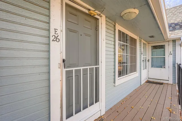 a view of front door and porch with wooden floor