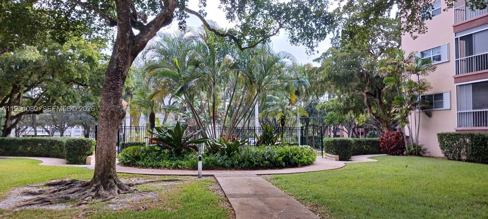 6731 Cypress Road, Unit 310 Plantation, FL 33317 - Photo 14 of 16 a view of a garden with a tree