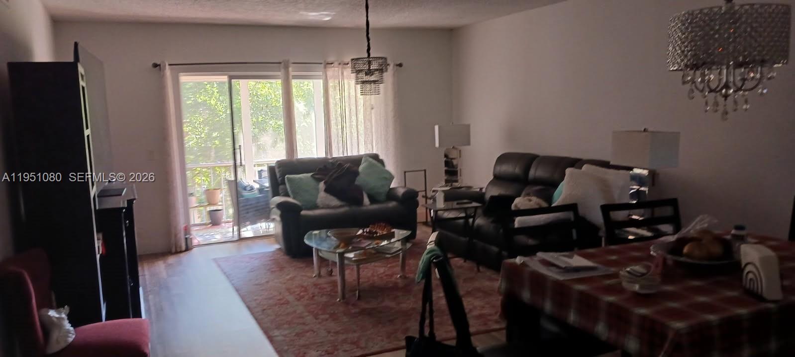 6731 Cypress Road, Unit 310 Plantation, FL 33317 - Photo 2 of 16 a living room with furniture and a flat screen tv