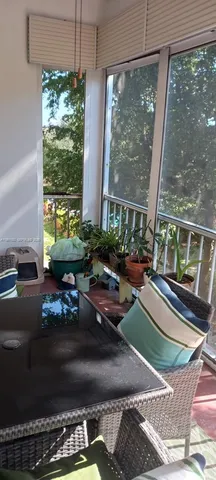 a living room filled with furniture and a floor to ceiling window