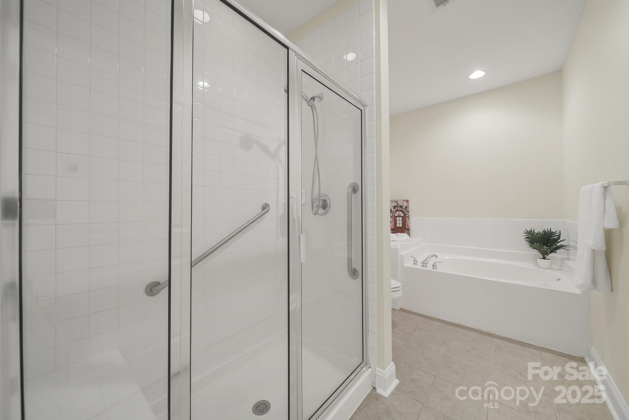 2959 Bellasera Way Matthews, NC 28105 - Photo 17 of 30 a bathroom with a bathtub and a shower