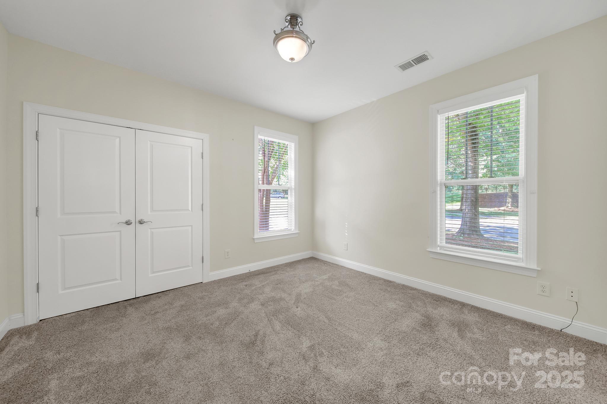 2959 Bellasera Way Matthews, NC 28105 - Photo 18 of 30 an empty room with windows and closet area