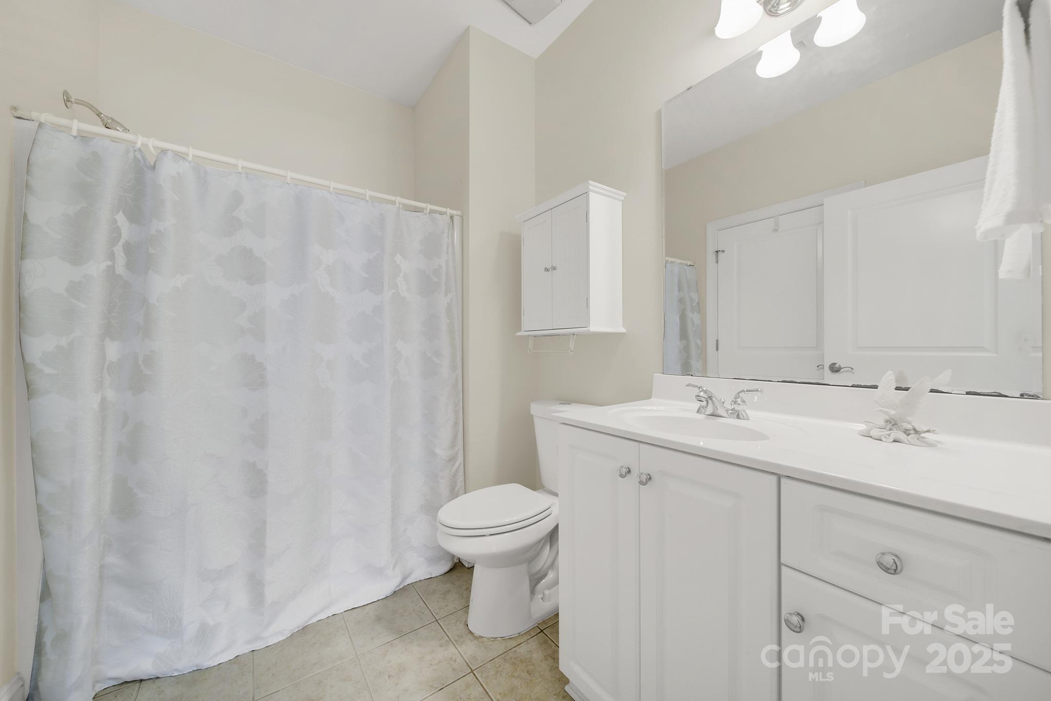 2959 Bellasera Way Matthews, NC 28105 - Photo 21 of 30 a bathroom with a sink a toilet and a mirror