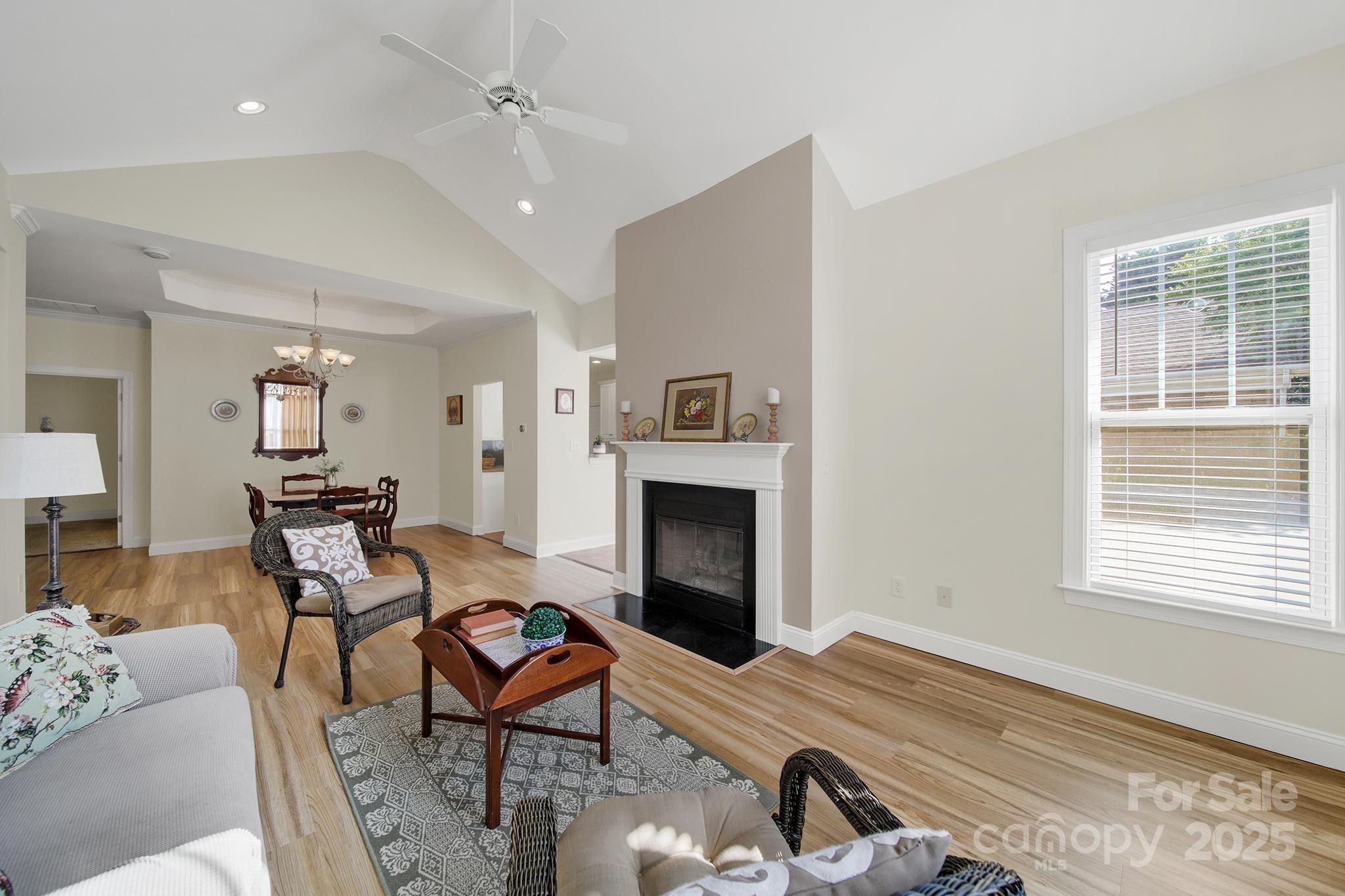 2959 Bellasera Way Matthews, NC 28105 - Photo 7 of 30 a living room with furniture a fireplace and a window