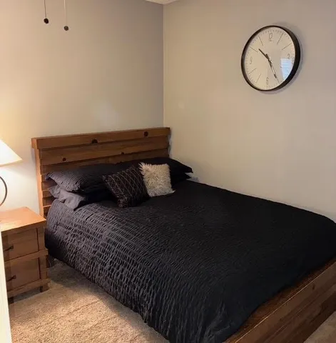 a bed sitting in a bedroom next to a window