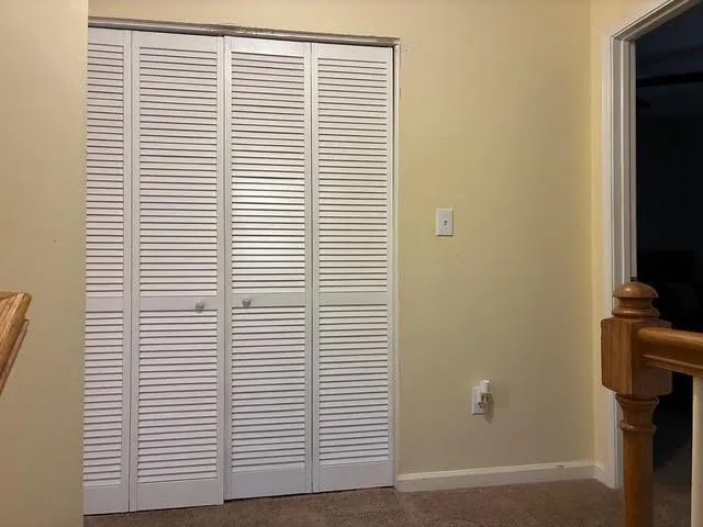 a view of a room that has a window and a door