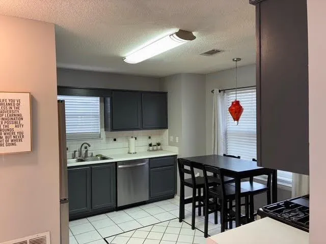 a room with a wooden table and chairs
