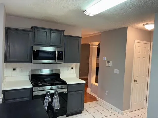 a kitchen with stainless steel appliances a refrigerator a stove a microwave and cabinets